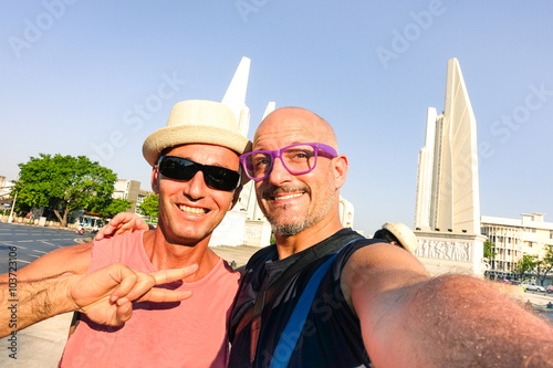 Photography Happy couple of male friends taking selfie at Bangkok Democracy Monument - Cheer
