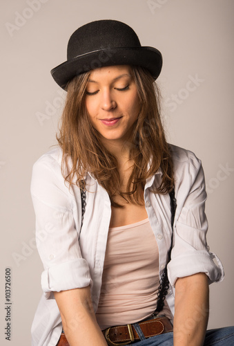 Sexy girl in studio with hat