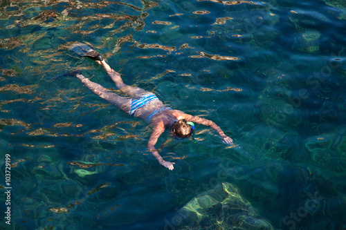 Young woman snorkeling in tropical lagoon