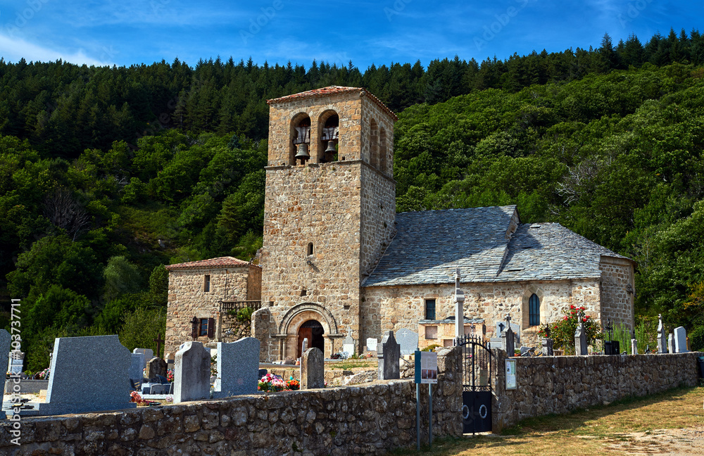 Cemetery and medieval stone church with a bell tower in Prunet, Rhone-Alpes, France.