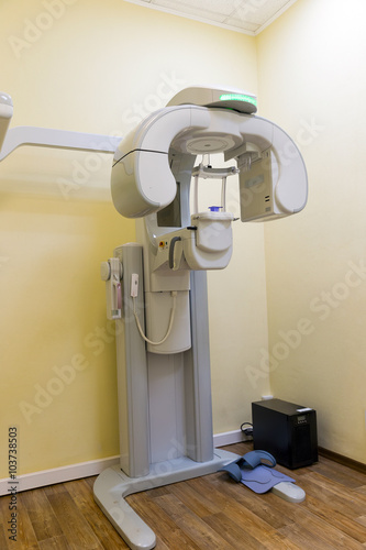 Digital dental CT scanner with cephalostat in clinic interior photo
