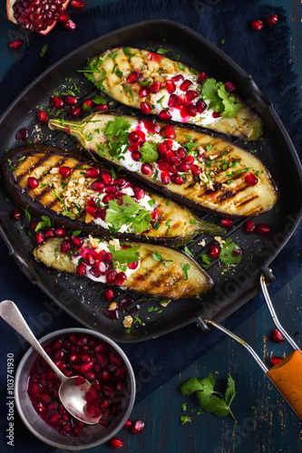 grilled eggplants with garlic yogurt sauce, walnuts and pomegran photo