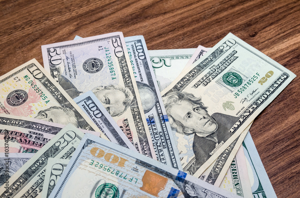 different dollar face-value banknotes on table different dollar face-value banknotes on table