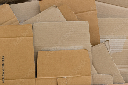 Pieces of recycled cardboard flattened and arranged pile
