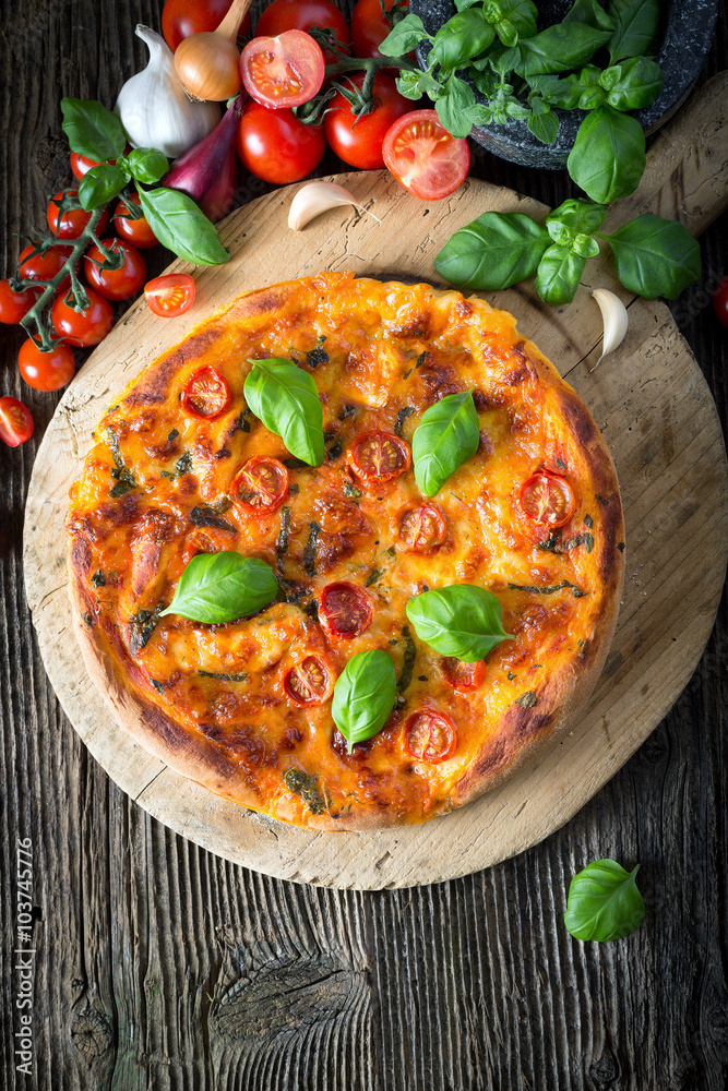 homemade pizza margherita with mozzarella, basil and tomatoes homemade pizza margherita with mozzarella, basil and tomatoes