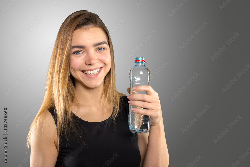 Beautiful young woman with bottle of mineral water Beautiful young woman with bottle of mineral water