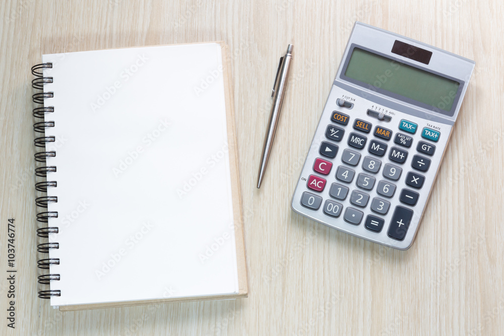 Top view of notebook, calculator and pen Top view of notebook, calculator and pen