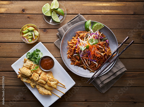 beef pad thai and chicken satay dinner viewed from above