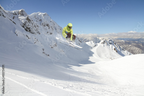 Flying skier on mountains. Extreme sport.