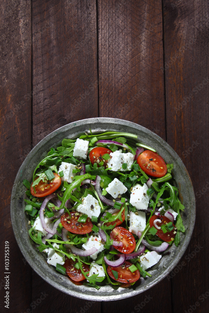 Salad with arugula, tomato, cheese and red onion