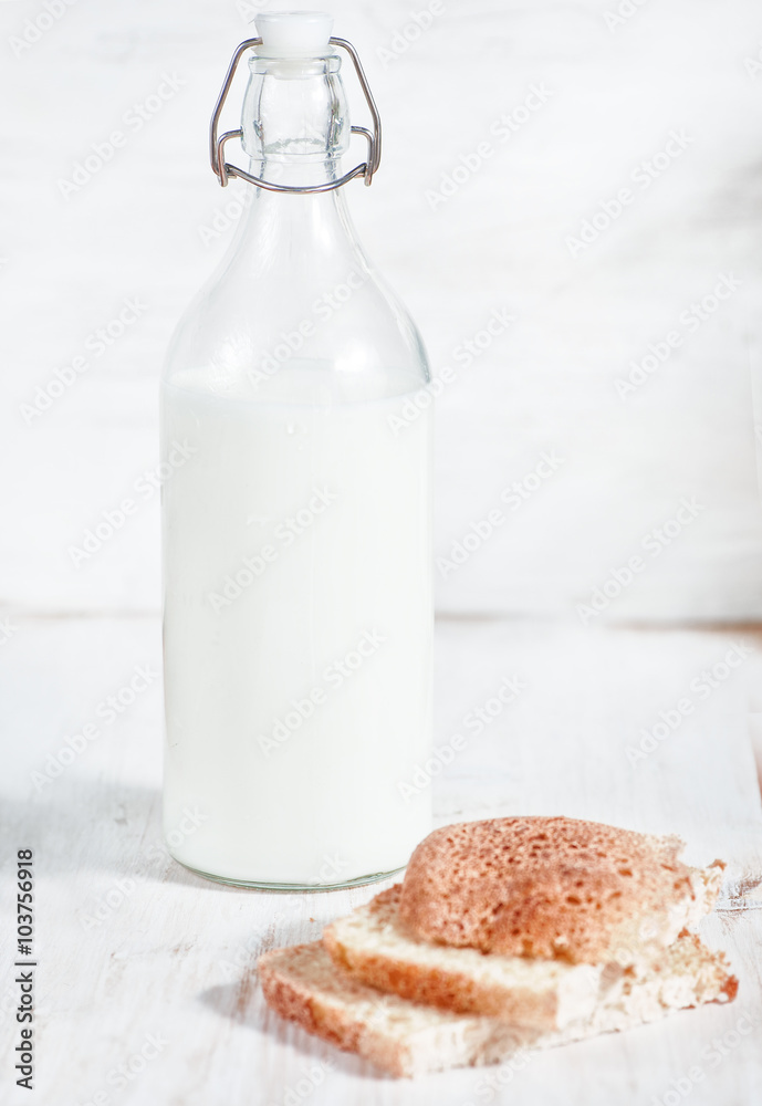 Fresh milk in old fashioned bottle and homemade bread Fresh milk in old fashioned bottle and homemade bread