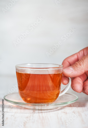 Man hand holding cup of tea