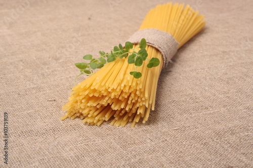 Close up of spaghetti and oregano on fabric photo