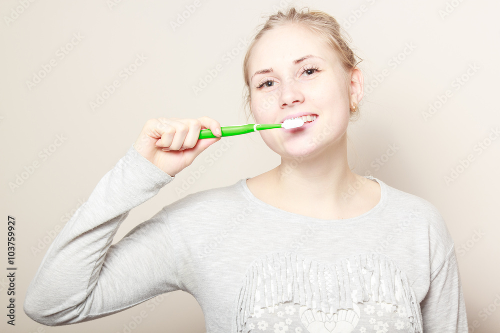 young beautiful woman brushing her teeth young beautiful woman brushing her teeth