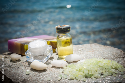 Natural facial cream soap oil and sea as background 