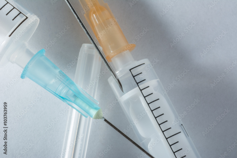 syringes with needles on a white background  - obrazy, fototapety, plakaty 