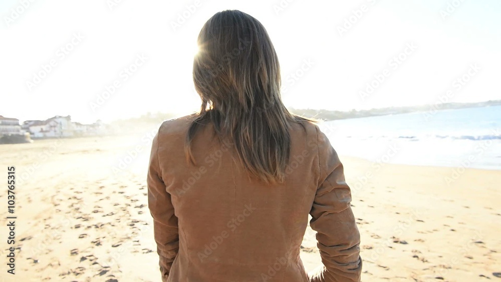 Cheerful beautiful woman walking on the beach Cheerful beautiful woman walking on the beach