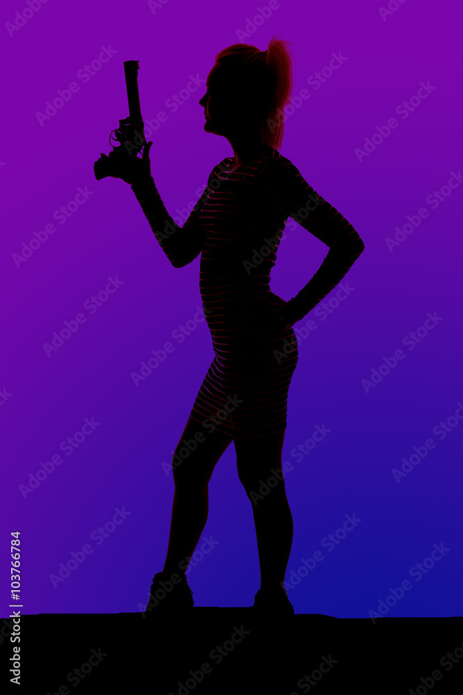 silhouette of a woman in heels and a dress with gun stand side silhouette of a woman in heels and a dress with gun stand side