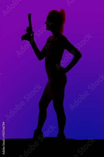 silhouette of a woman in heels and a dress with gun stand side