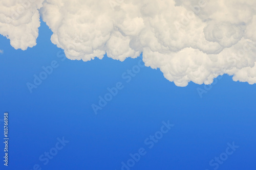 fluffy cloud on clear blue sky