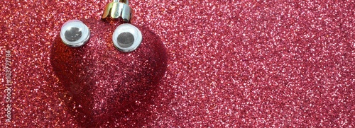 Photography red heart with big languid eyes on red background