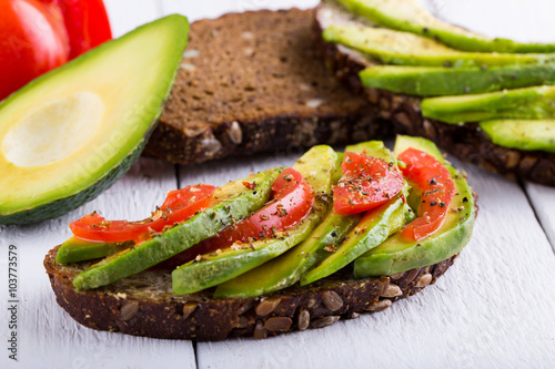 Tasty avocado sandwich with tomato and seasoning for slimming.
