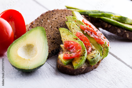 Tasty avocado sandwich with tomato and seasoning for slimming.