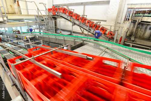 Automation in the food industry - empty beer boxes on the flowing ribbon