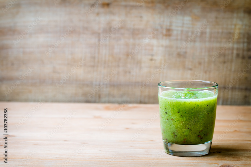 Healthy green smoothie in a glass on old wood. Healthy green smoothie in a glass on old wood.