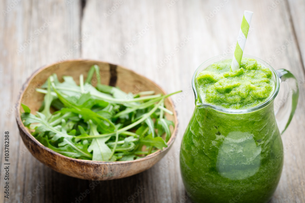 Rucola smoothie, on the grey background. Rucola smoothie, on the grey background.