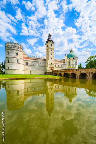 A view of beautiful Krasiczyn castle and its reflection in a lake on a sunny summer day, Poland