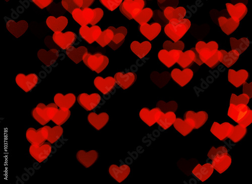 Many red hearts on black background