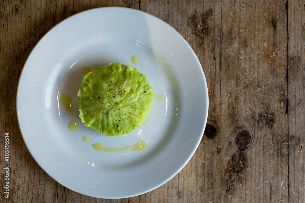 Green mashed potato with parsley, from above wide. French restaurant prepared mash, green due to inclusion of parsley, with olive oil and peppercorns
Green mashed potato with parsley, from above wide. French restaurant prepared mash, green due to inclusion of parsley, with olive oil and peppercorns