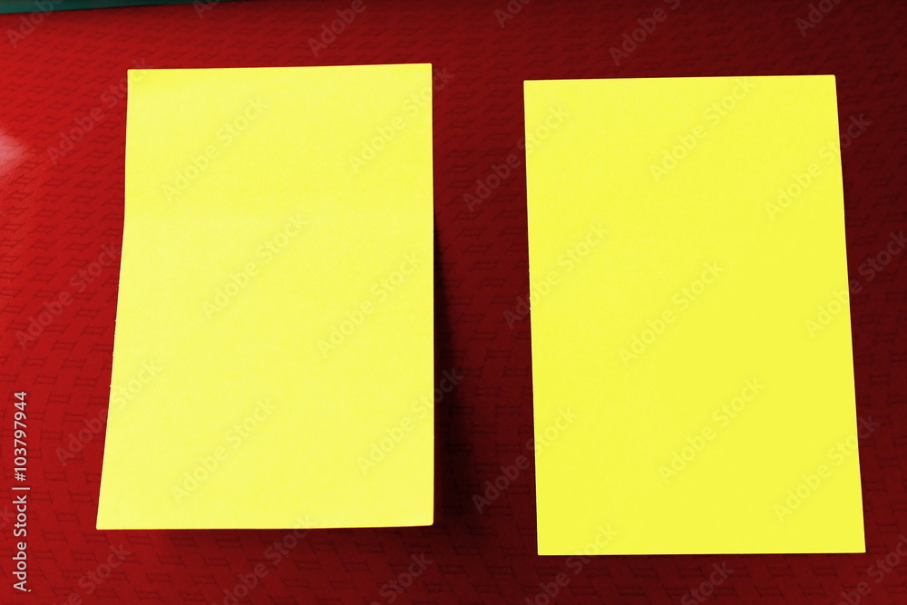 Two yellow reminder notes on a portable computer red patterned Two yellow reminder notes on a portable computer red patterned