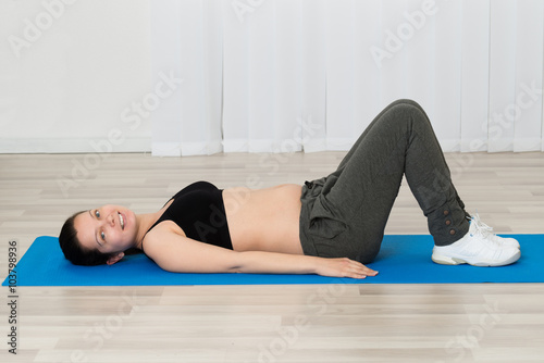 Pregnant Woman Lying On Exercise Mat