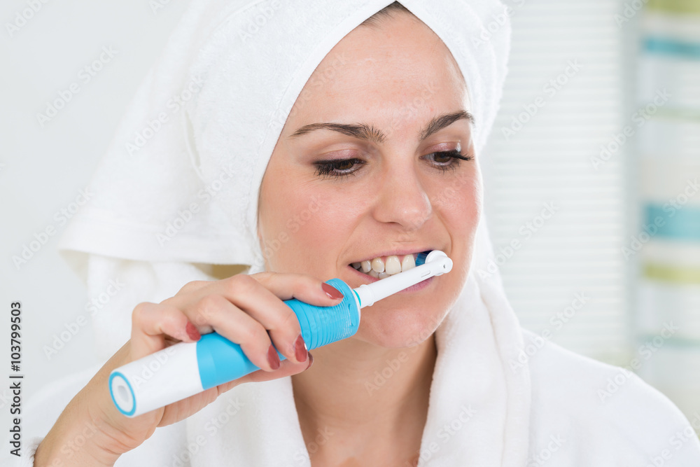Woman Brushing Teeth With Electric Toothbrush Woman Brushing Teeth With Electric Toothbrush