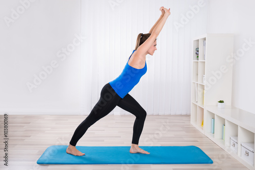Woman Doing Yoga In Her Living Room