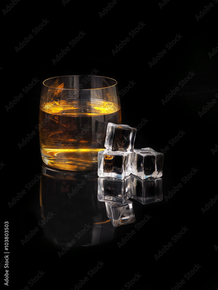 glass of whiskey and ice on a black background