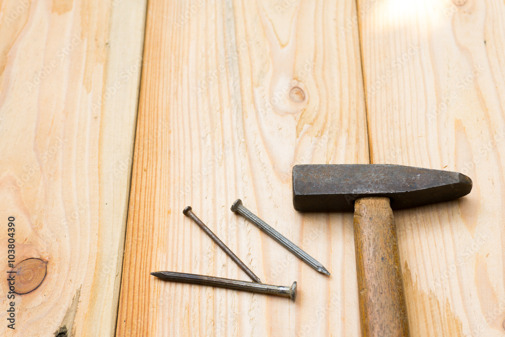 Hammer and nail on wood