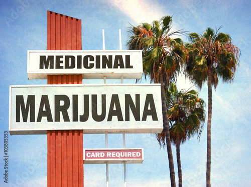 aged and worn vintage photo of medicinal marijuana sign with palm trees