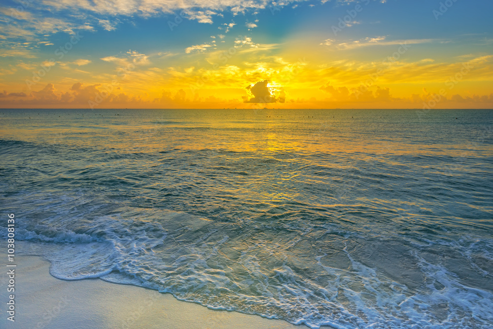 Colorful sunset on the tropical beach with beautiful sky, clouds