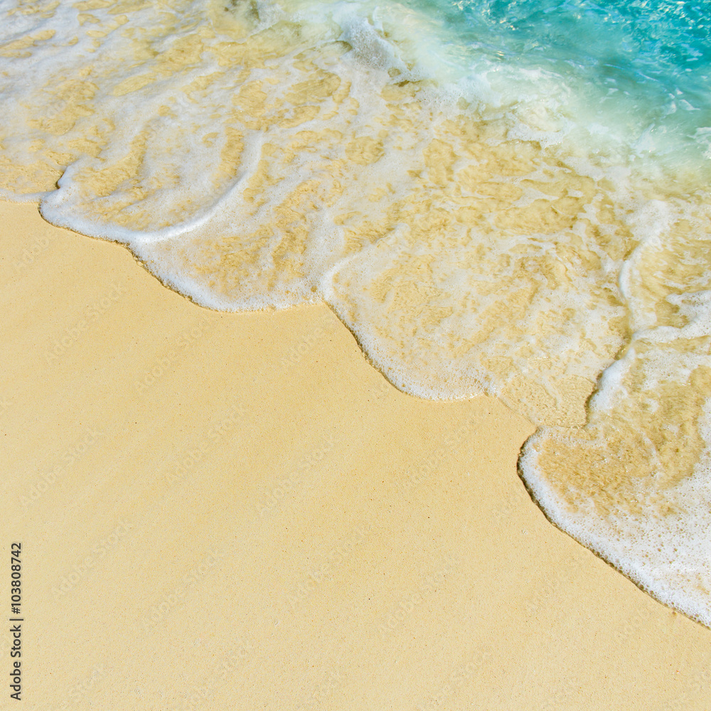 Soft wave of the tropical sea on the sandy beach