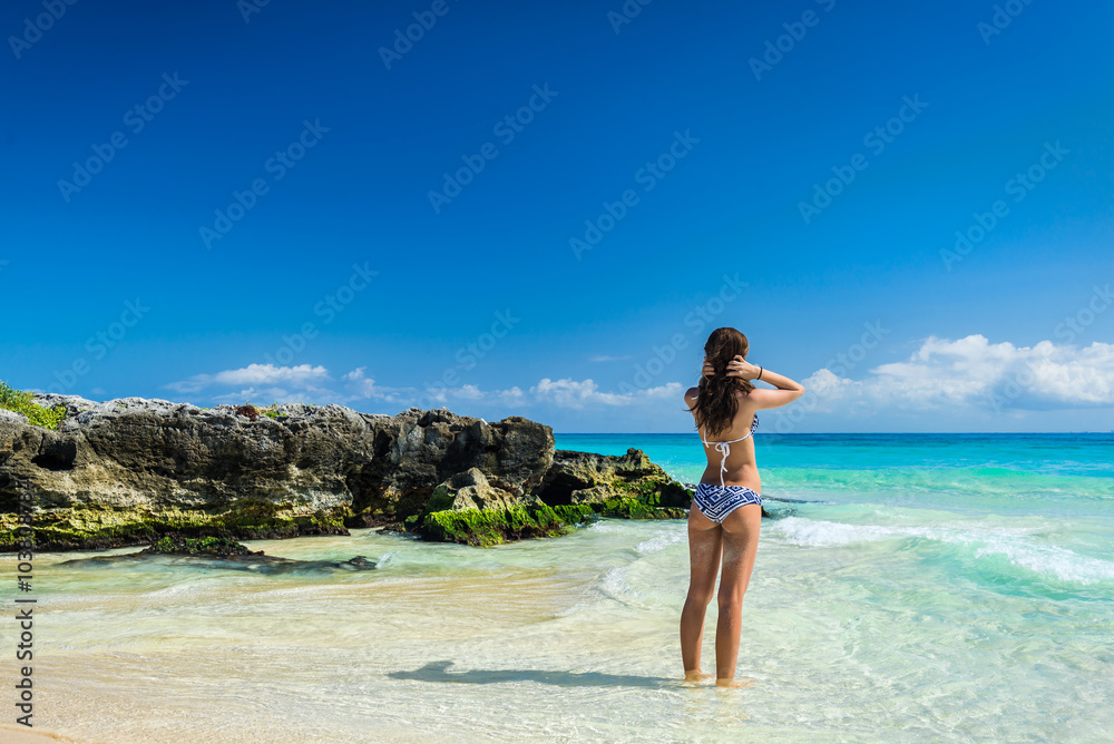 Beautiful girl in a swimsuit on the sea. Woman with a beautiful