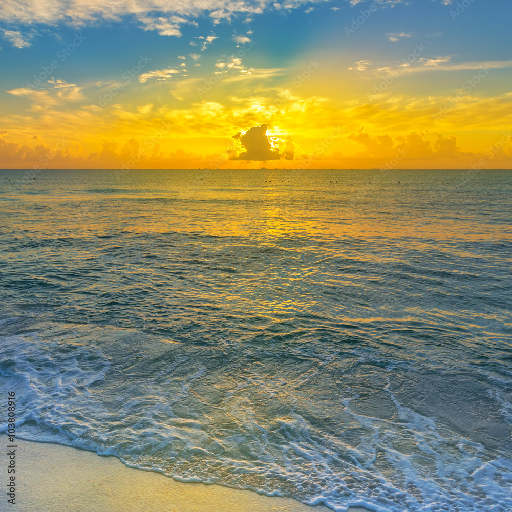 Colorful sunset on the tropical beach with beautiful sky, clouds