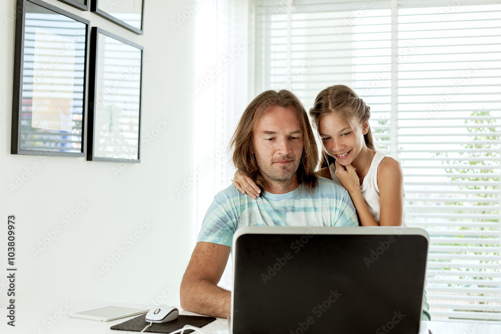 Dad with his daughter using laptop. Dad with his daughter using laptop.