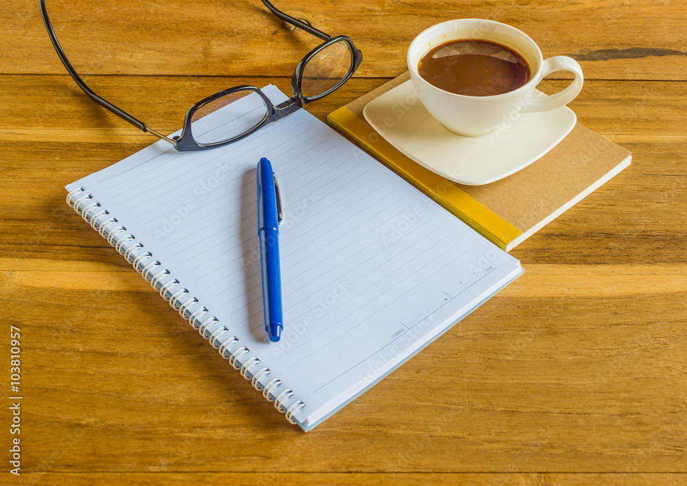 View from above ,office table with notepad,Pen,glasses and coffe View from above ,office table with notepad,Pen,glasses and coffe