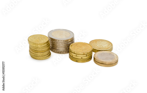 Different stacked euro coins on a light background