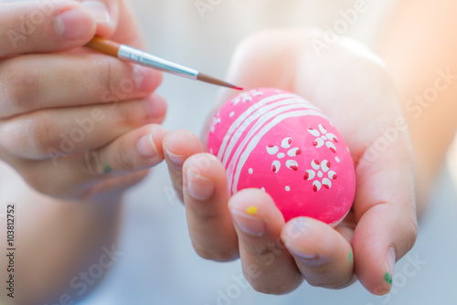 Woman hand decorating Easter eggs