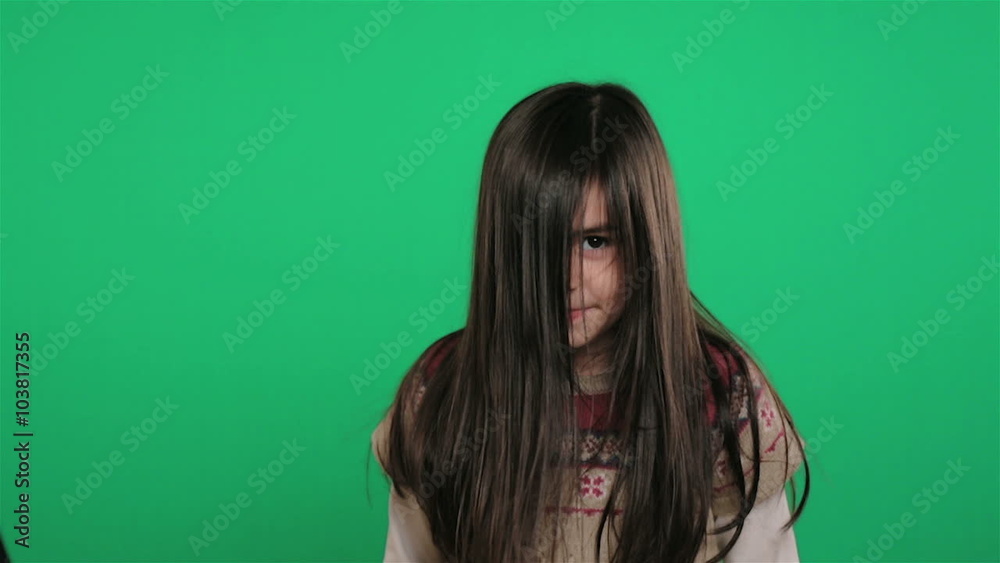 young girl shaking hair on green screen