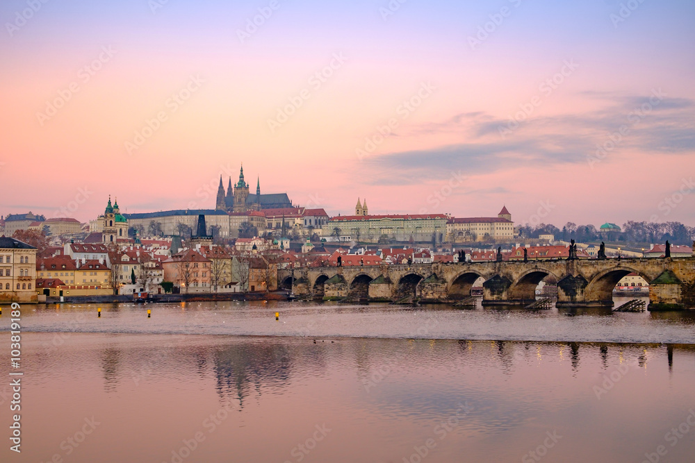 View of Prague castle and Charles bridge at colorful sunrise